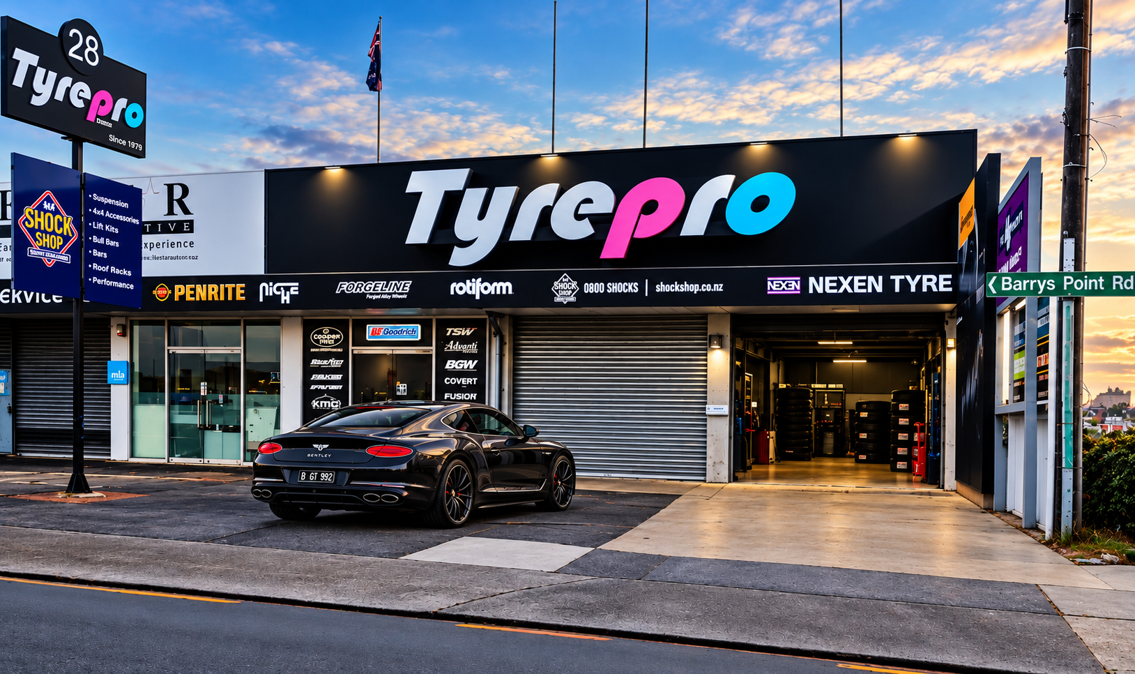 TyrePro on Barrys Point Road, Takapuna, with a Bentley parked out the front
